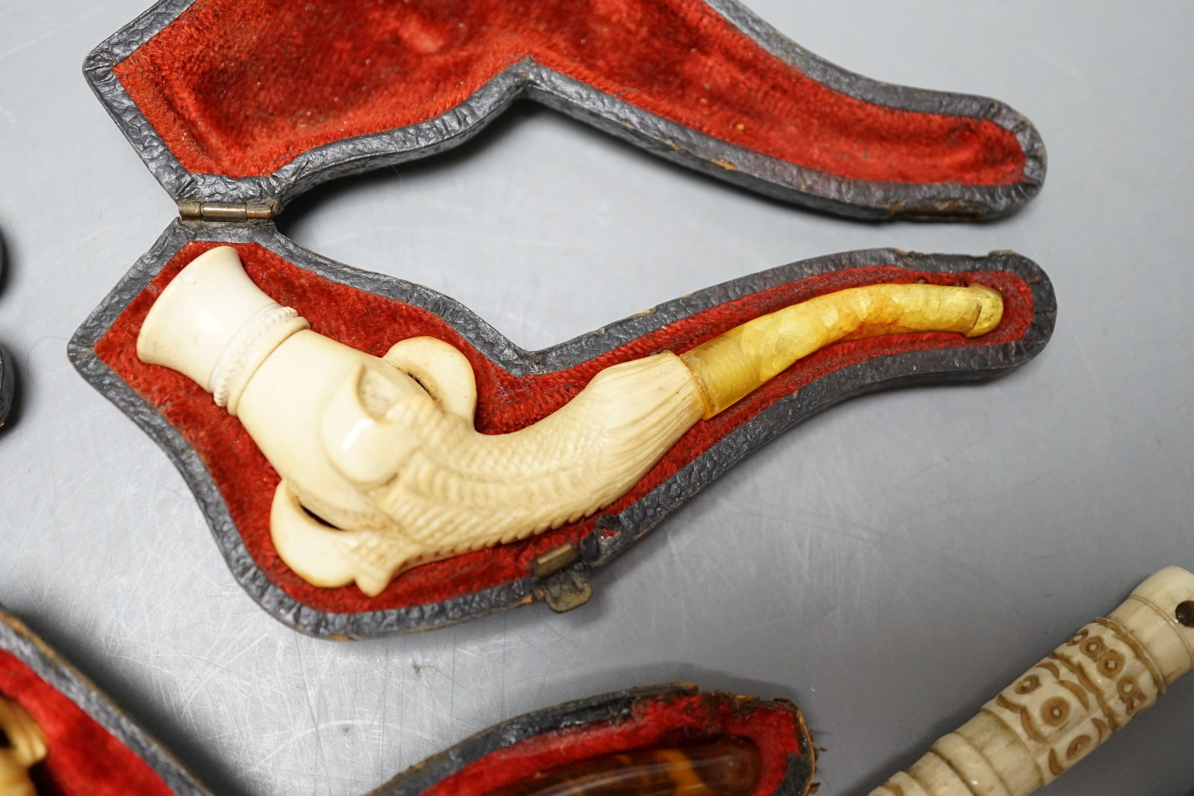 Three cased meerschaum pipes, another pipe and two bone cheroot holders